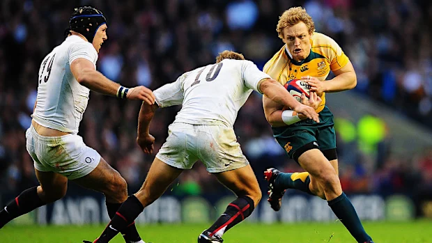 Ryan Cross, da Austrália, é abordado por Jonny Wilkinson, da Inglaterra.