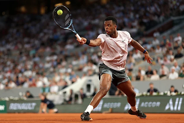 Giovanni Mpetshi Perricard, da França, joga backhand contra Novak Djokovic, da Sérvia.